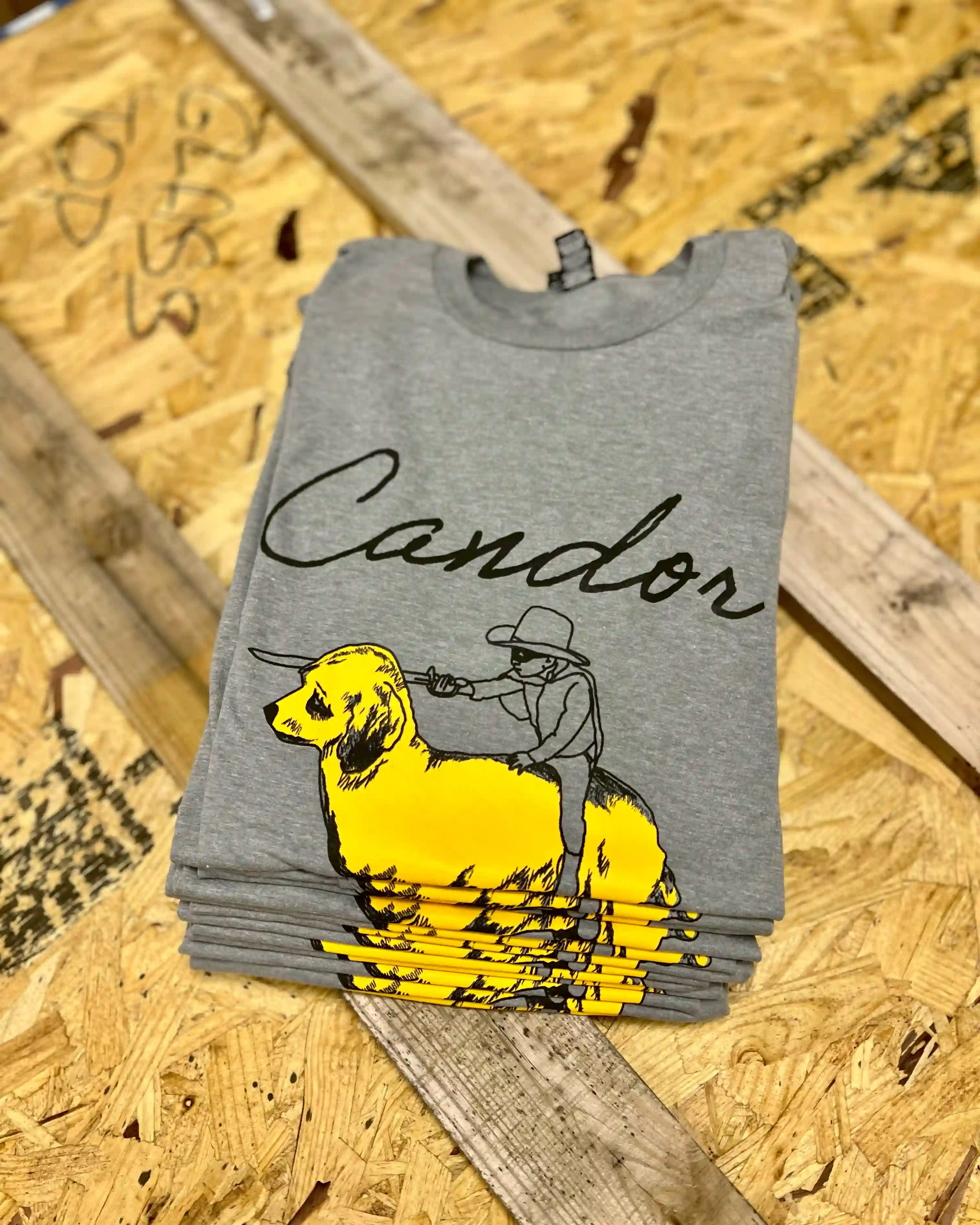 Stack of custom-printed Candor shirts produced by First Brothers